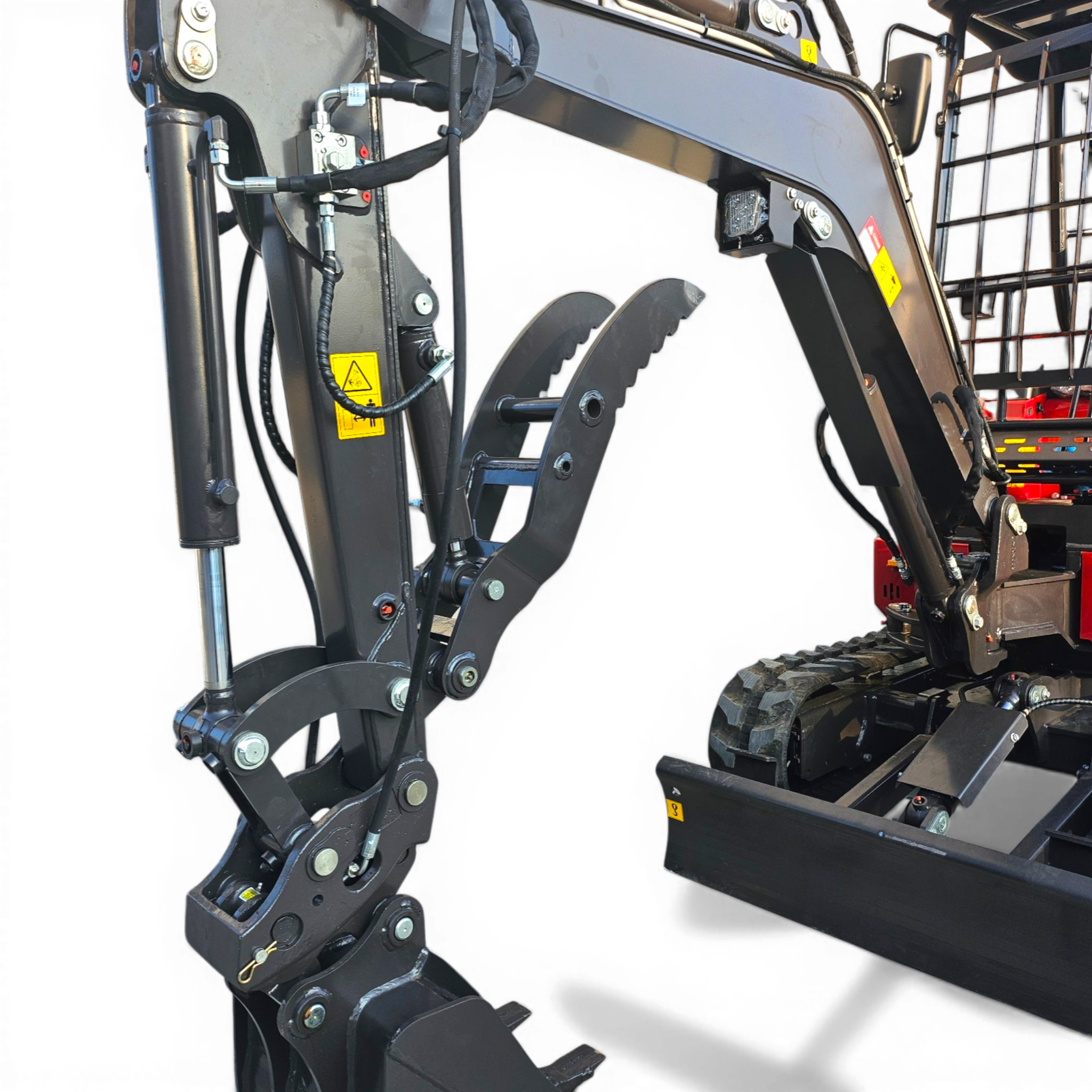 Close-up of a hydraulic excavator arm with hoses, metal joints, and warning labels visible on the equipment.