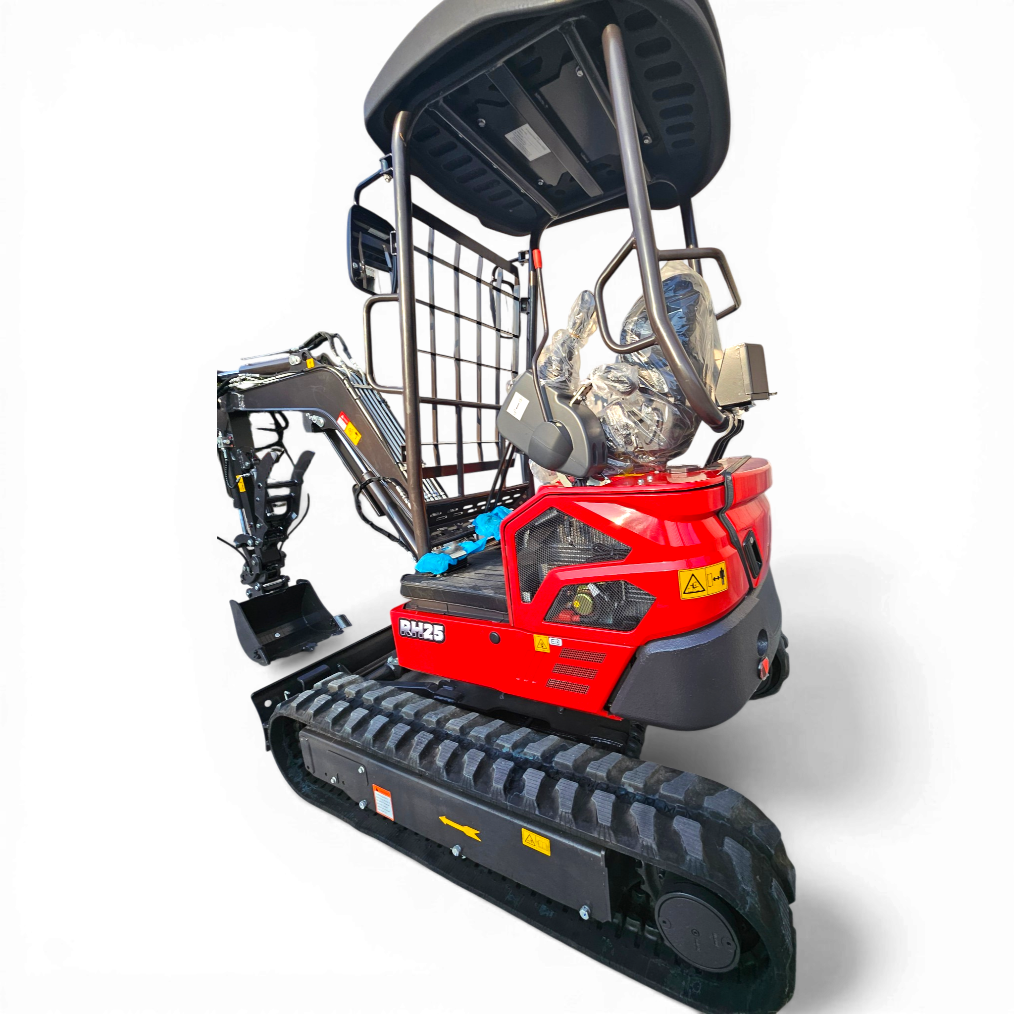 Close-up of a red tracked construction vehicle’s rear section, showing metal frame, wheel guards, and warning labels.