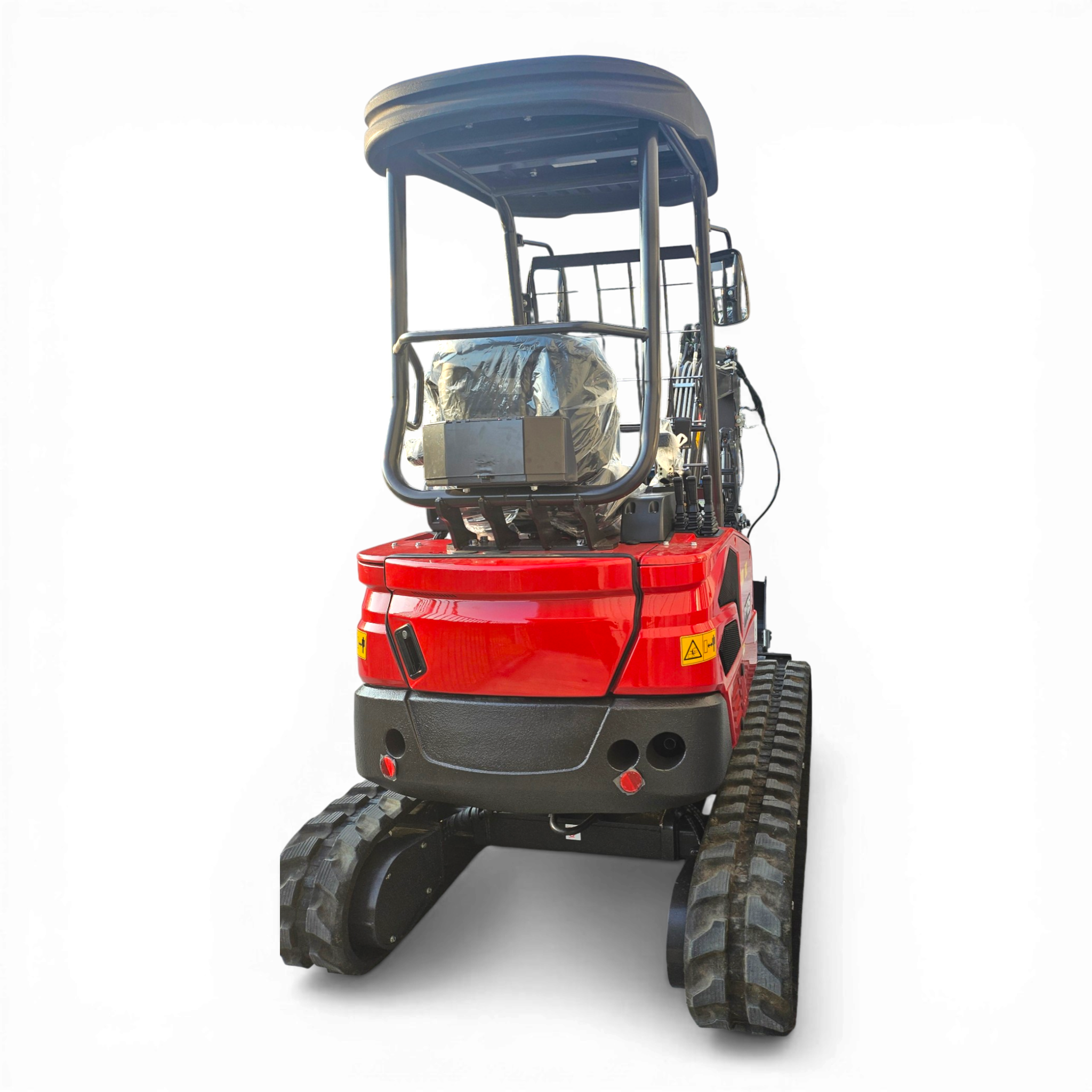 Red compact excavator with open cab and protective canopy, showing large tracked undercarriage and hydraulic gear behind the cabin.