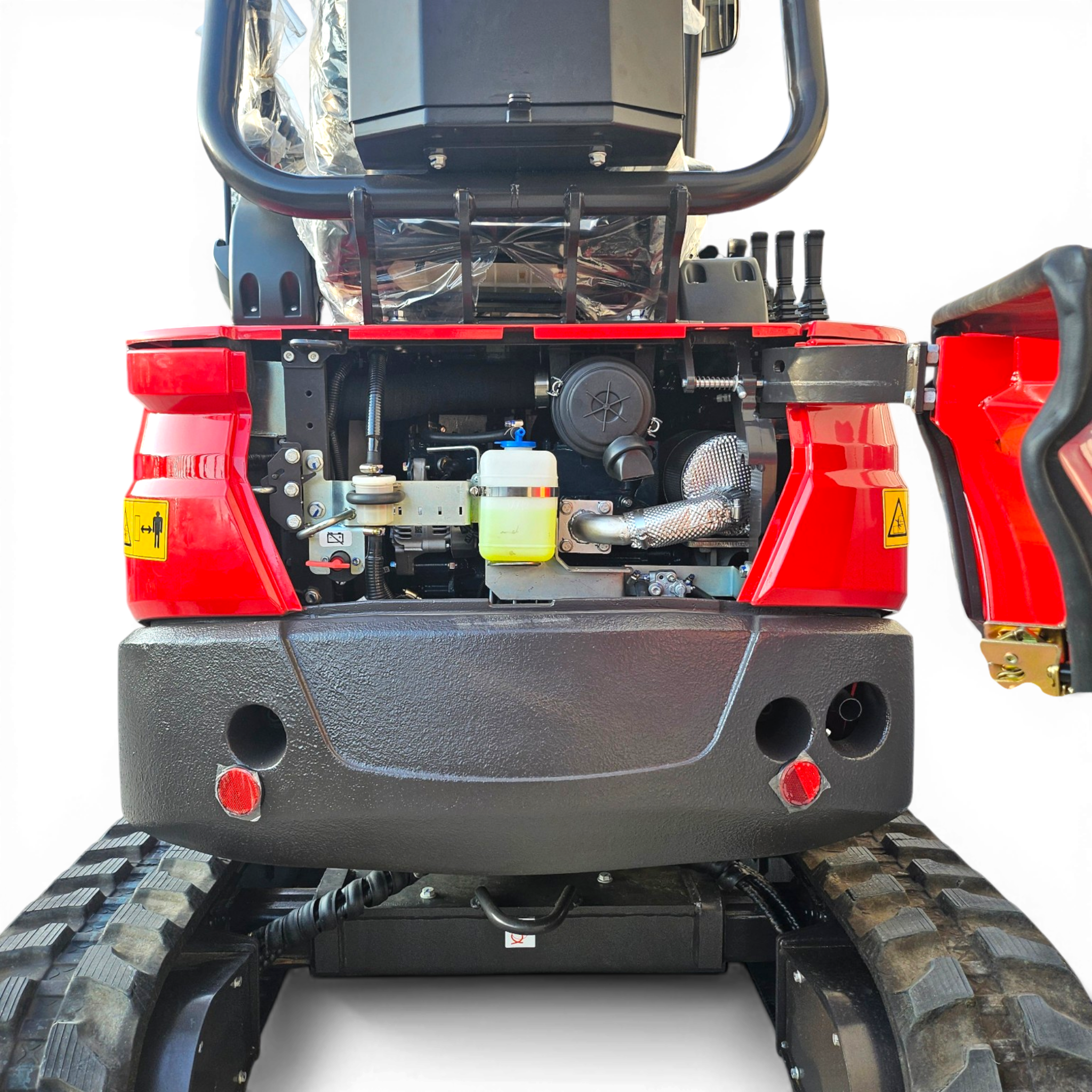 Rear view of a red heavy machinery vehicle showing exposed engine components, hoses, and two large tracks on either side.