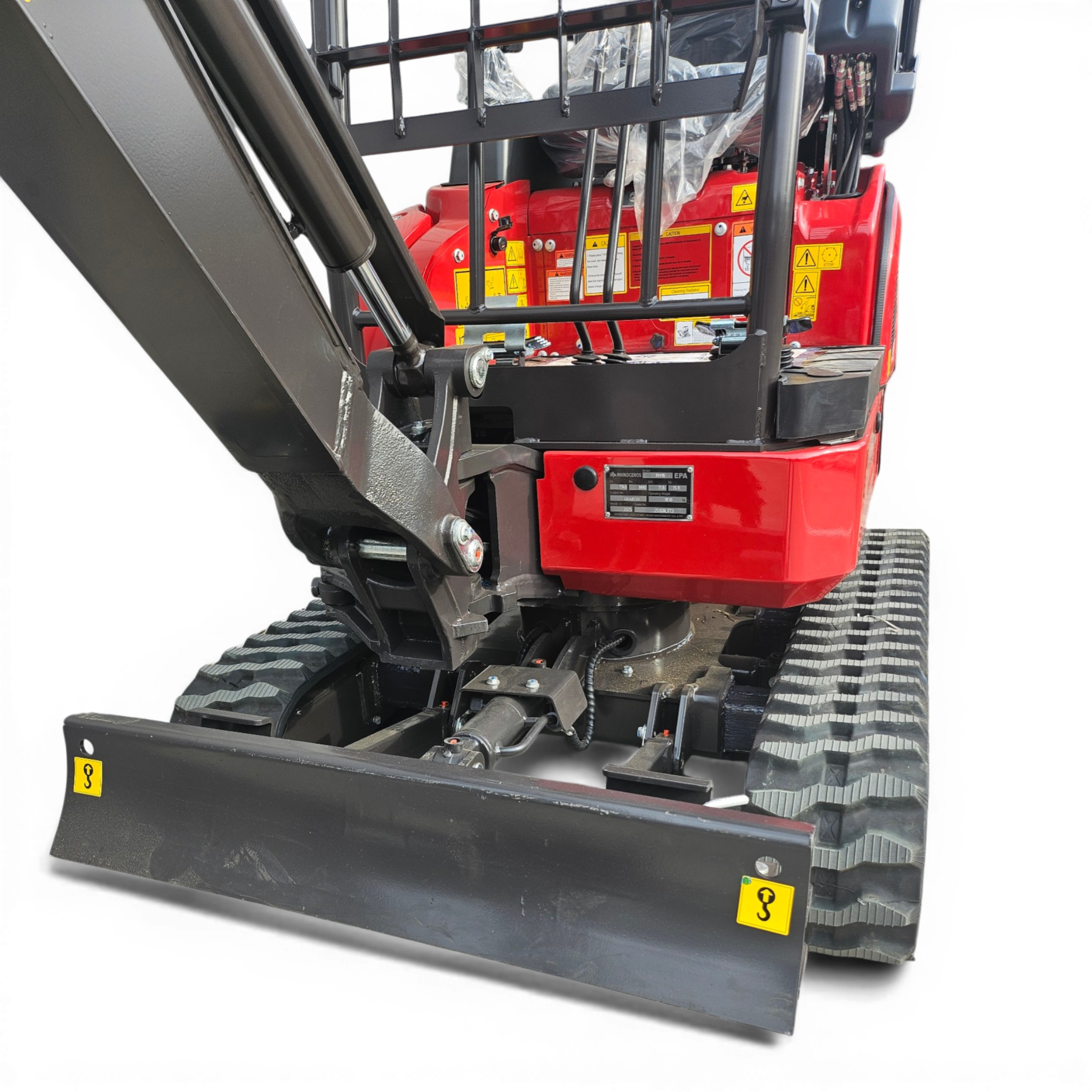 Close-up of a red industrial forklift cabin with hydraulic arms and safety warning stickers visible on the side trenching the frame of the forklift