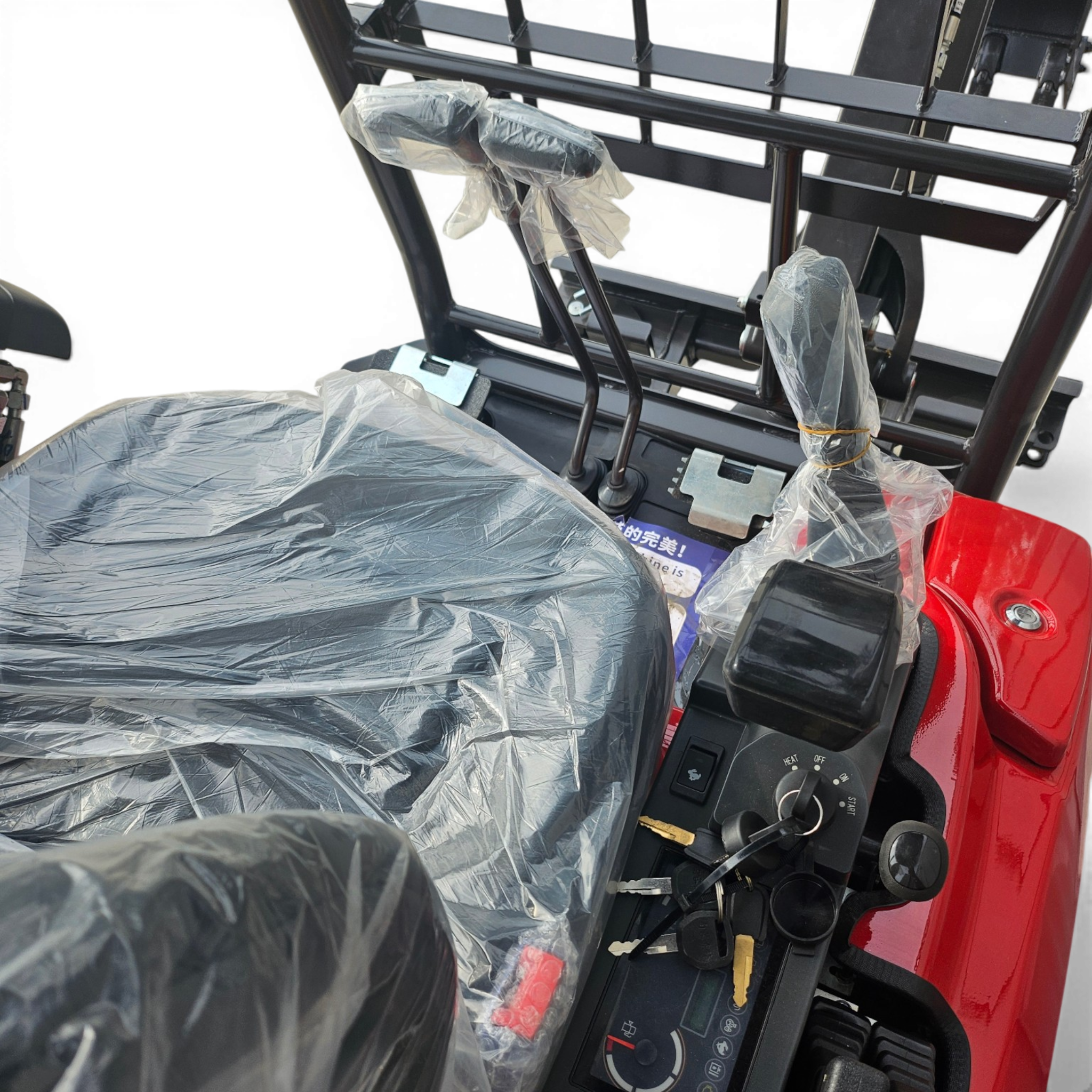 New car interior with protective plastic on the seats and gear area, dashboard controls visible