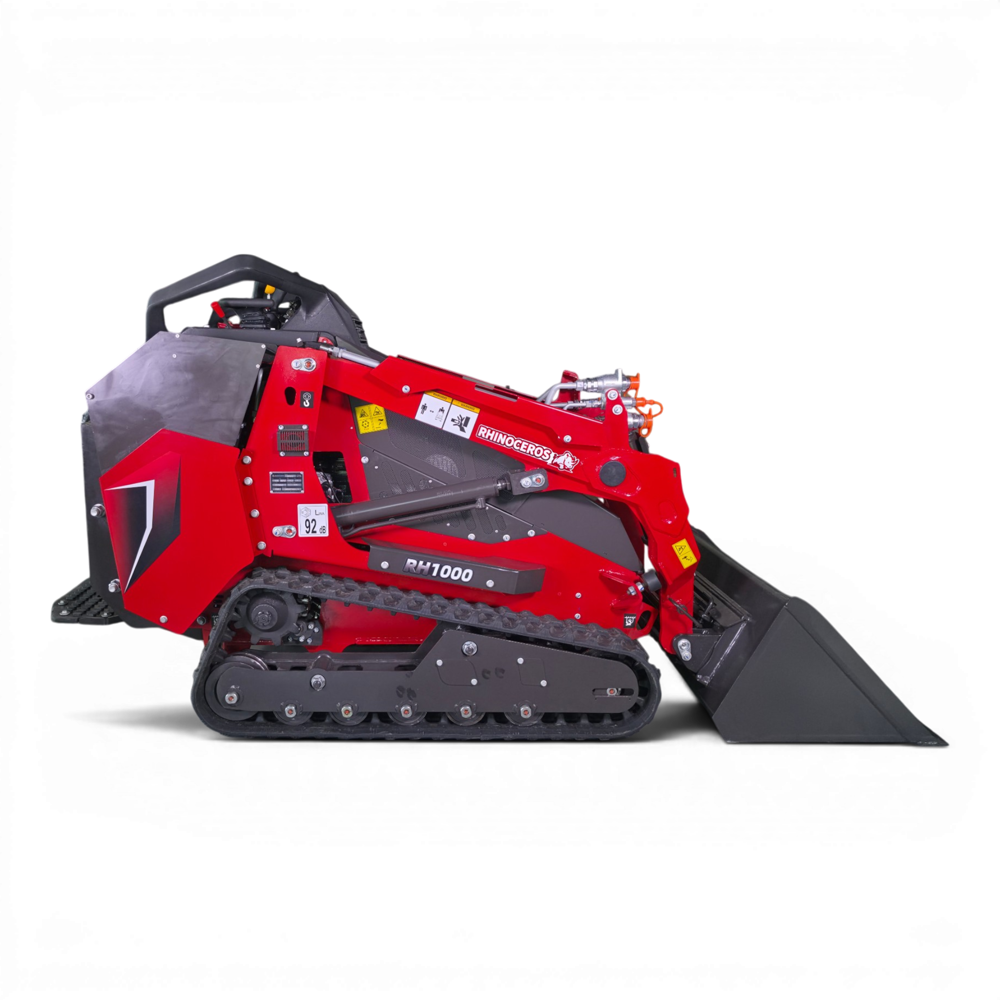 Red tracked industrial snow blower seen from the side, with handles, warning labels, and a metal intake shield.