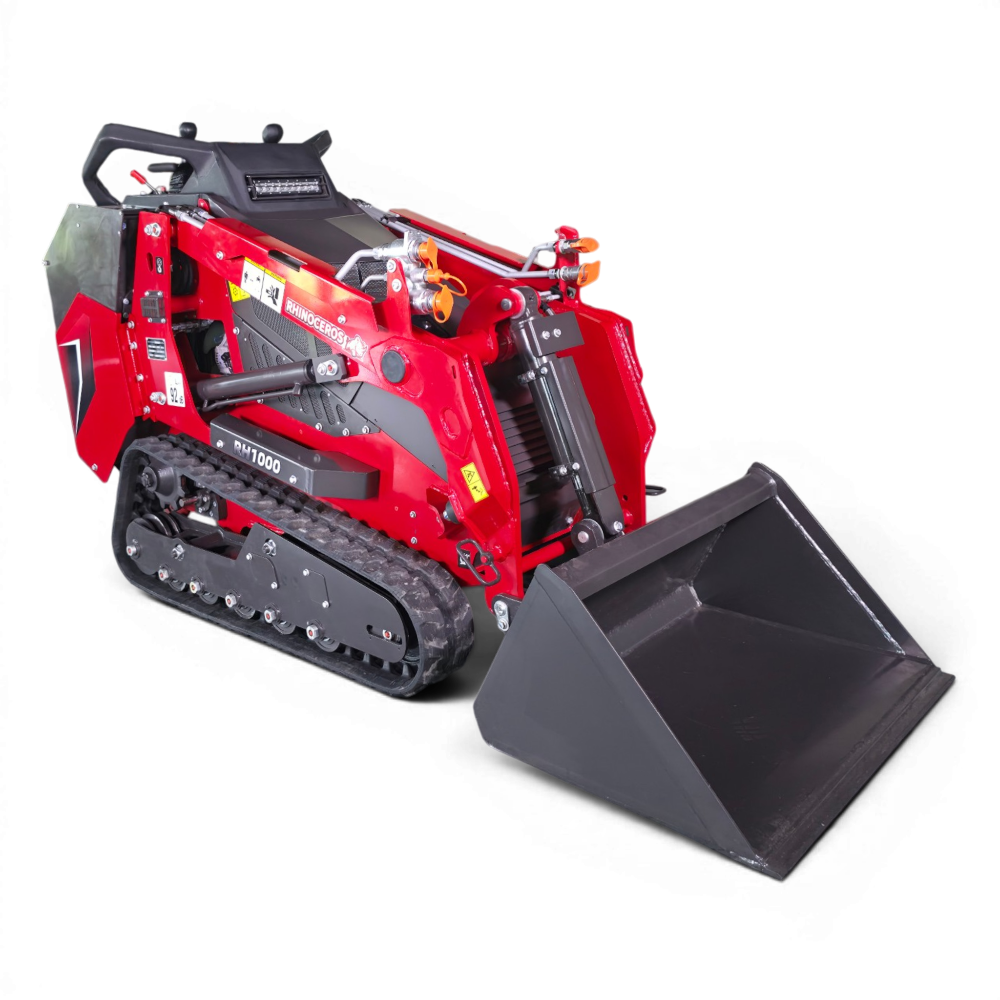 Red compact tracked loader with a large gray snow plow blade attached, showing hydraulic hoses and safety decals for snow removal.