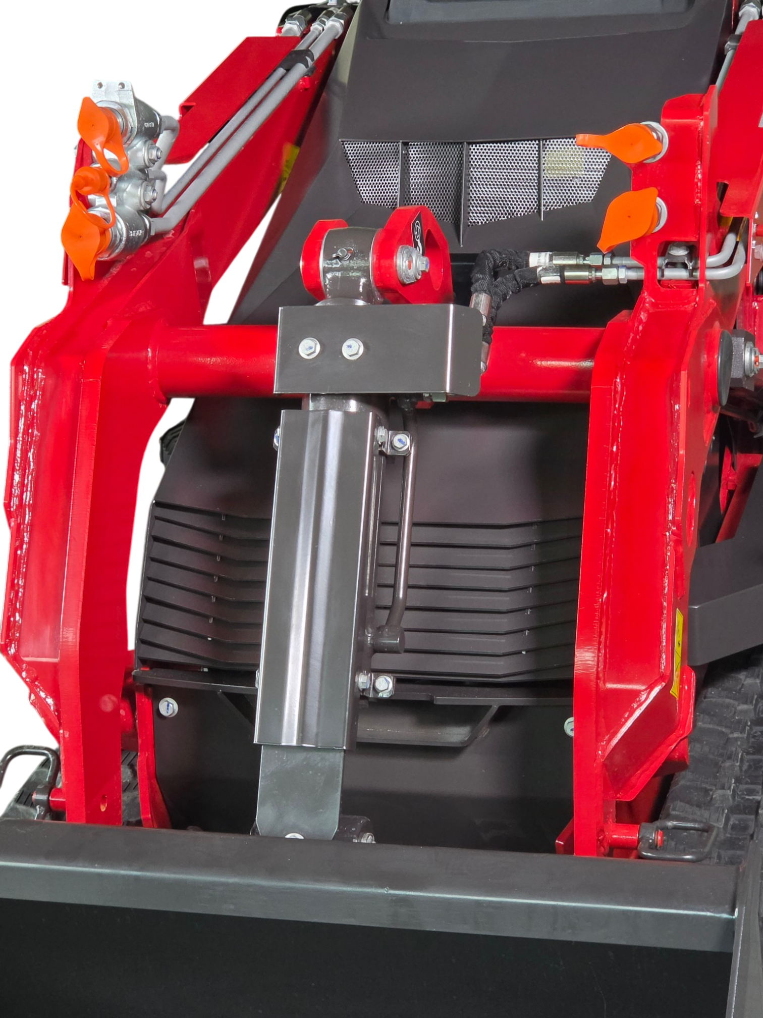 Close-up of red industrial machinery frame with orange handles, hydraulic lines, and a black grill component.