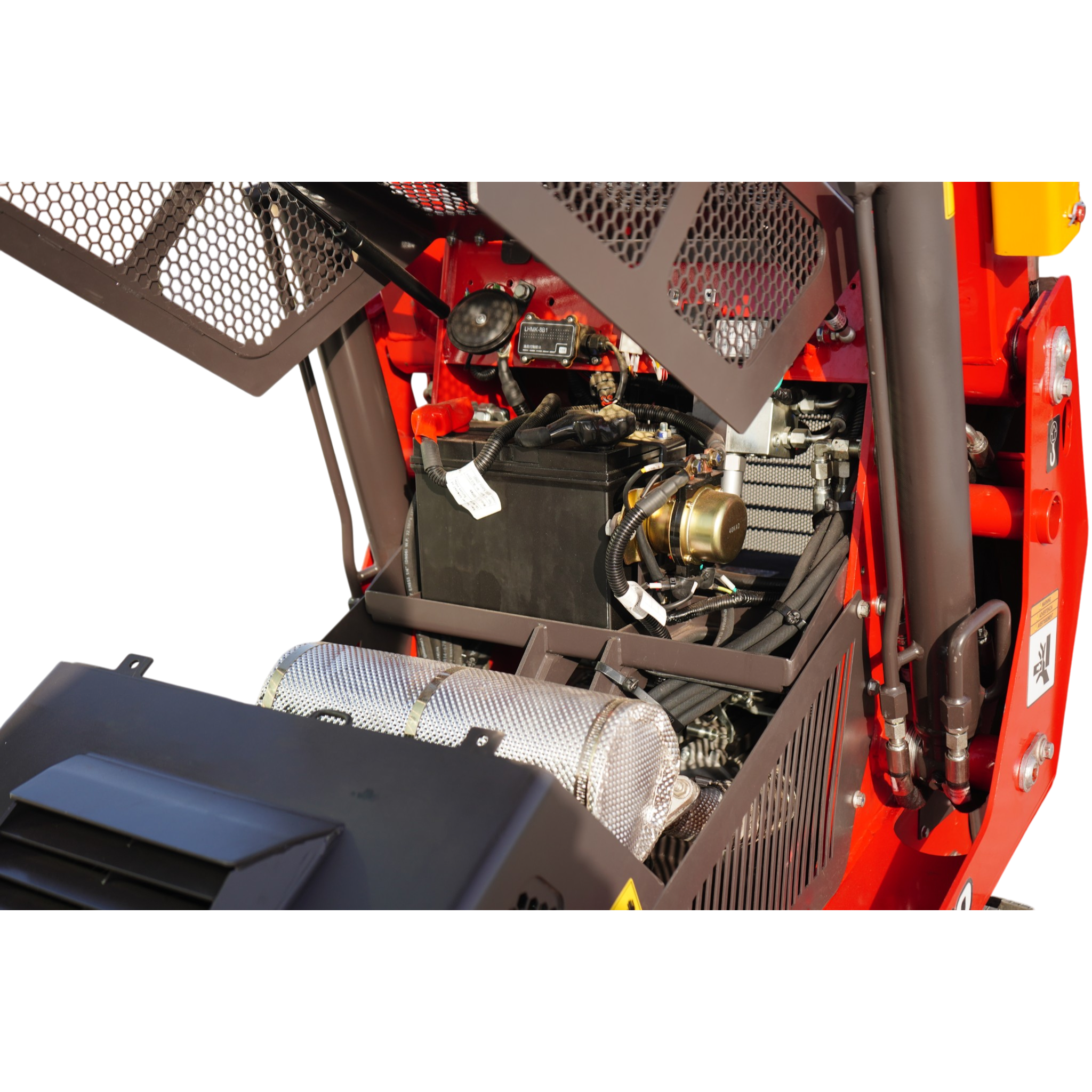 Close-up of red industrial equipment with metal mesh guards, wires, and a battery pack behind the guard.