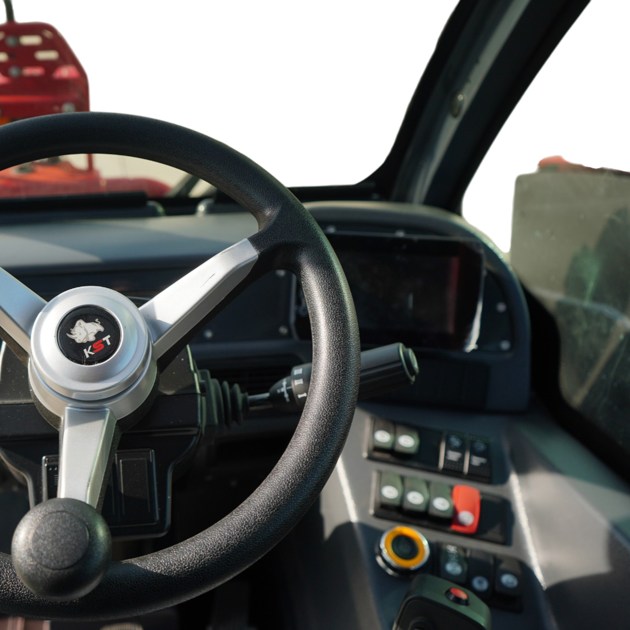 View of a car interior from the driver's seat: steering wheel, dashboard controls, and center console visible.