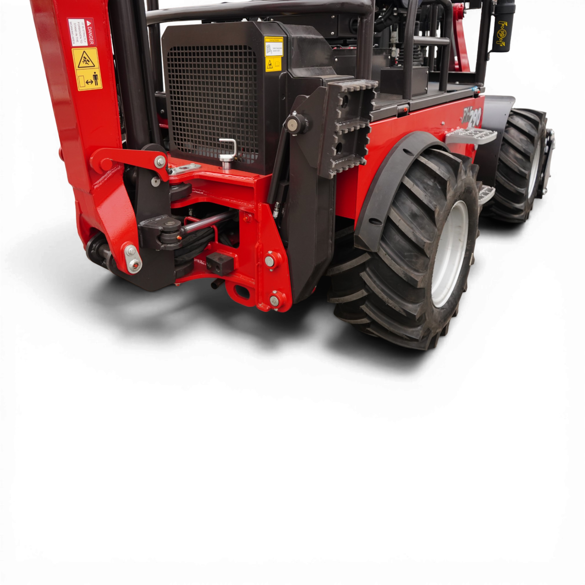 Close-up of red industrial machine frame with a black radiator grille and large treaded tire visible on the right side