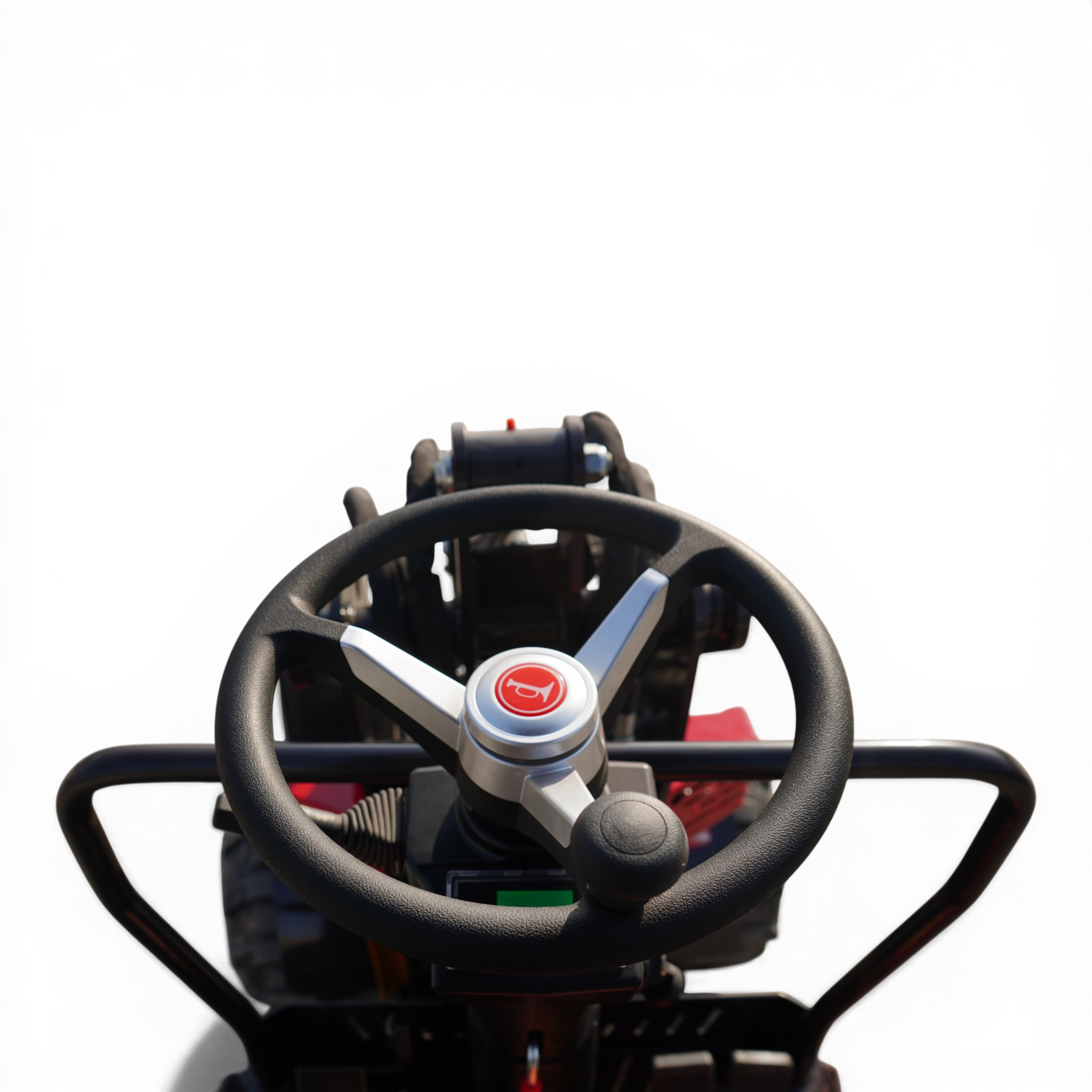 Close-up, driver’s view of a steering wheel with dashboard controls visible behind it.