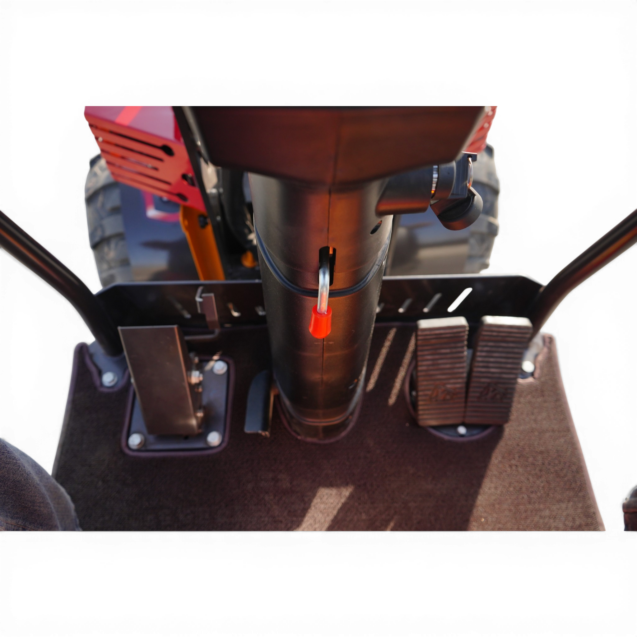 Close-up of a red-and-black motorcycle handlebar assembly with a safety tether hanging down and various controls visible beneath.