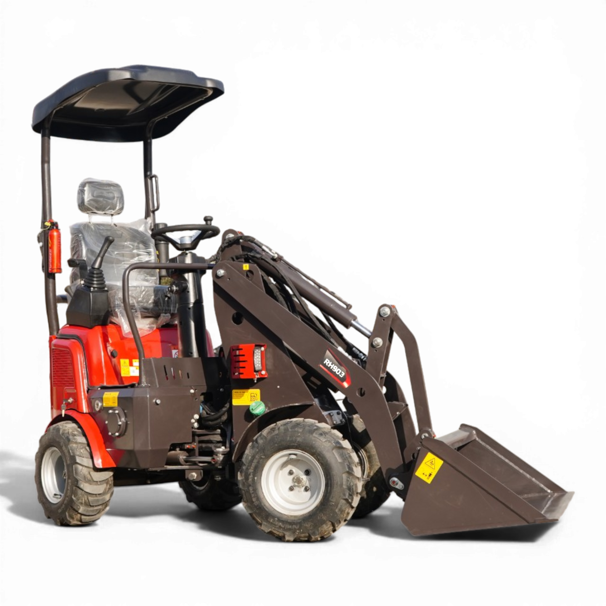 Front view of a red compact tractor with a large front loader bucket and protective canopy, wheels visible on the ground pieces.